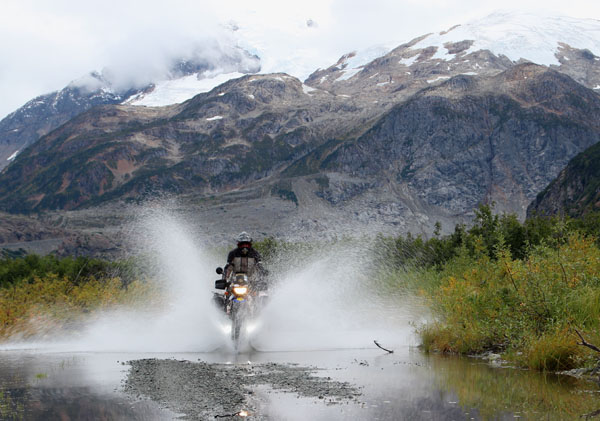 Photo of Alexander taken by Alexander Conrad (Germany) - Hyder, Alaska - Crossing a flooded dirt road on his 2003 BMW F650GS Dakar. www.dakaralex.de.