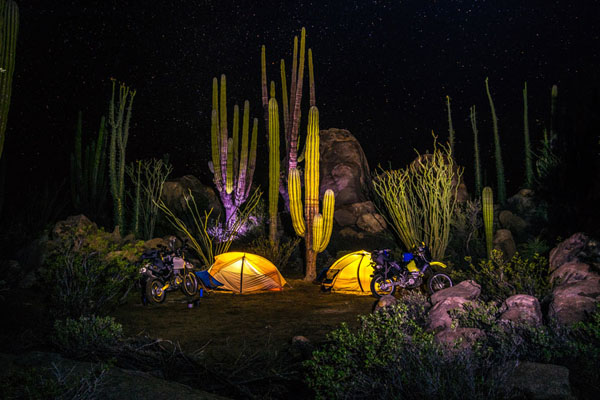 Photo by Mark Newton (USA) of moto camping in the foothills of Sierra de San Borja, Baja California Sur, on the Panama Tour. Suzuki DR650 and Suzuki DRZ 400E.