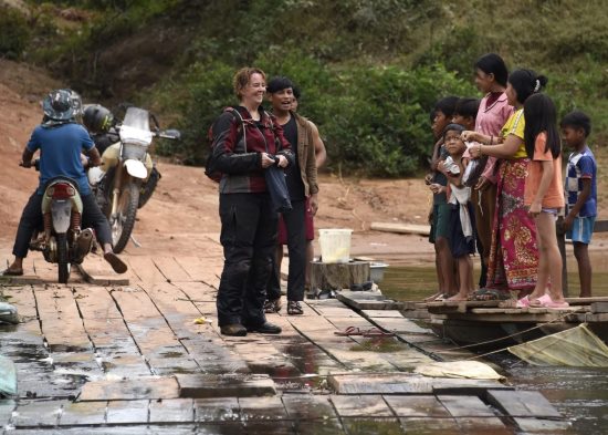 Bec Fox, standing on a wooden bridge.