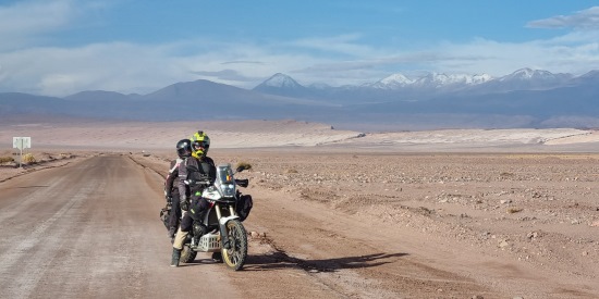 Adela Vancea and Andrei Baraian, Riding two-up on a desert road.