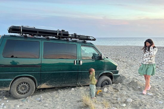 Theodor Pana family and van close-up on a beach.