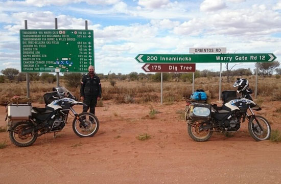 Tyson and Sarah in front of road signs