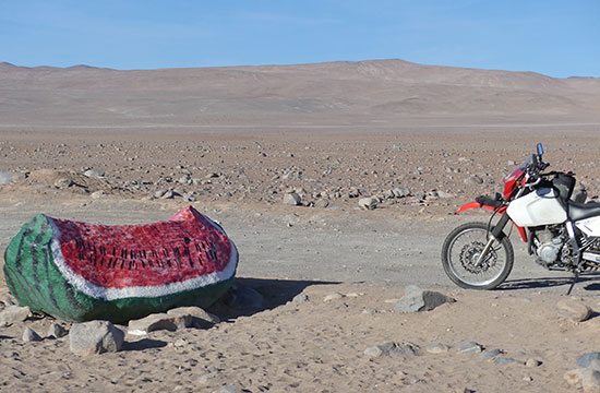 Desert boulder painted like a watermelon.