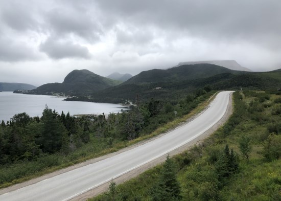 Lynn Howard, Cloudy day on a paved road by the water.