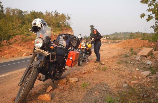 Jenny Colquhoun roadside with the bikes.