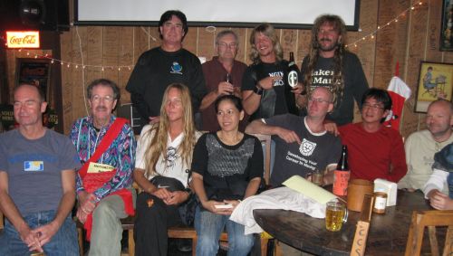 Some of the 40 attendees pose for a newspaper photo while watching a speaker introduce himself and his adventure.