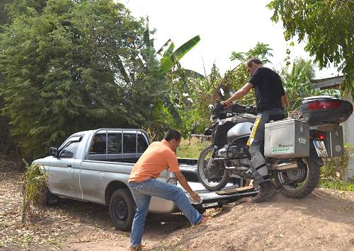 Bike being loaded on truck in Thailand.